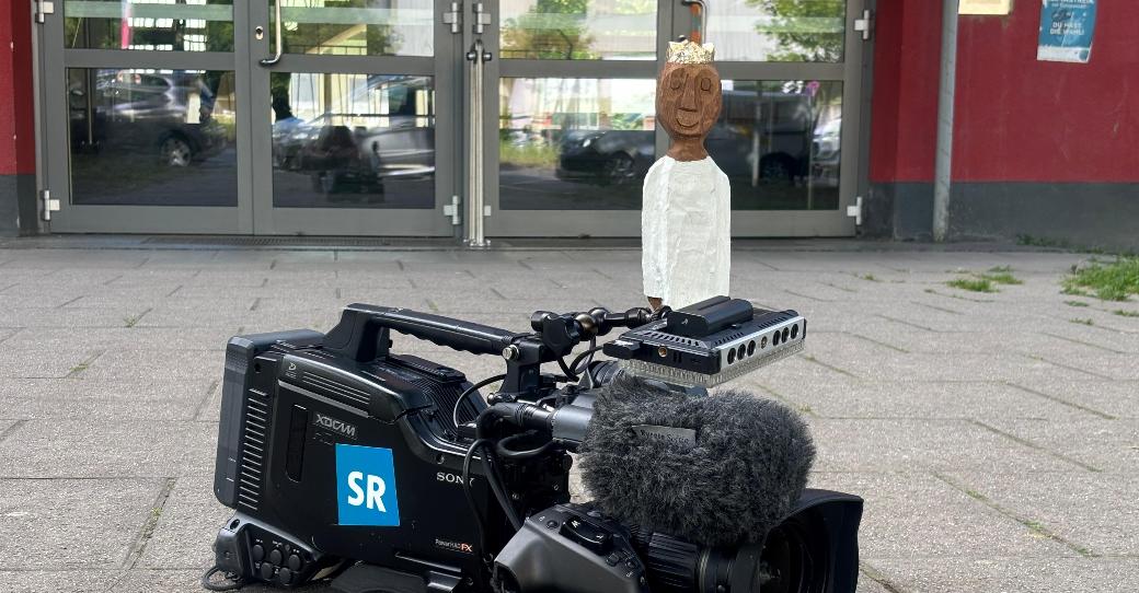 Königsfigur auf einer Kamera des SR vor der Marienschule